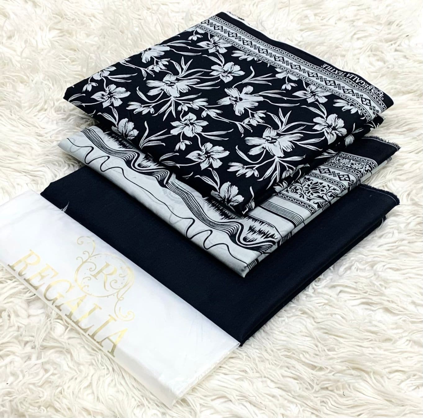 EGALIA-BLACK & WHITE-SERIES 2026 5 Elegant black and white traditional attire with floral and geometric patterns, perfect for cultural.